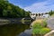 A dam on the Brno Reservoir by the Svratka River with a small power plant. Beautiful sunny summer day in nature