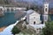 Dam, church and its bell tower in the lake of Isola Santa, magic in the heart of the Apuan Alps, in the province of Lucca.