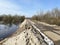 Dam, an earthen embankment protecting the road from spring floods and river overflows