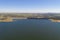 Dam lake reservoir drone aerial view of Barragem do Caia Dam olive trees landscape in Alentejo, Portugal