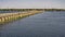 The dam of the sluice system crosses the blue river.