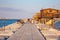 Dam of the tourist port of Sottomarina Chioggia along which tourists take long walks admiring the wooden huts of the fishing balan