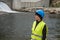 Dam and turbines of a hydroelectric power station with falling water flows and woman worker