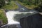 Dam wall and overflow of Iskar Dam. Water flowing over a dam wall. Mist rising above the Iskar dam wall. Cascade from a hydroelect