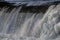 Dam, waterfall. the stream of the river falls from the dam in the winter. icy dam with a strong stream of the river. shiny drops o