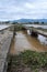 Damaged bridge across flowing river