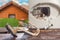 Damaged from corrosion and rust, the water heater lies on the background of the boiler on a wooden table. House on the background