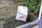 Damaged delivery cardboard box at front door of a house, Fragile package with dents, bad delivery concept
