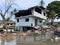 damaged house sinking in to the water in mangrove forest, collapsed old house in the water