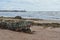 Damaged lobster metal trap on sand beach.