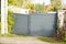 Damaged outdoor steel grey street gate aluminum broken portal of suburb home