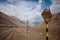 Damaged railway road sign near old abandoned railroad in desert in Andes Mountains