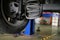 damaged rear car shock absorber & spring in auto repair garage