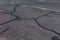 Damaged road, cracked asphalt sword with potholes and spots, Ukraine. Very bad asphalt road with large holes. Terrible technology
