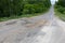 Damaged road, cracked roadway. Track with broken asphalt