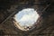 damaged roof hole exposes cloudy sky above Close up