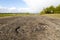 Damaged rural road, cracked asphalt blacktop with potholes and p