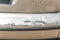 Damaged silver car front bumper with scratched and peeled paint close up