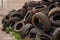 Damaged tires after high speed driving. Pile of used old damaged tires. pile of old car tires for rubber recycling