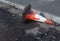 Damaged traffic cone in gutter, road undergoing repairs