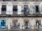 DAMAGED WOODEN DOORS AND WINDOWS ON OLD FACADE, HAVANA, CUBA