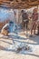 Damara men in traditional clothes demonstrating traditional fire making methods