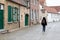 Damme, Flemish Region - Belgium - Woman walking through a cobble stone historical alley