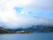 Dammed mountain lake high alpine landscape in clouds