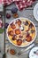 Damson blue plum clafoutis flan, icing sugar and almonds dressing, french cuisine