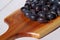 Damsons on wooden chopping board A