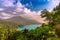 Danau Buyan Lake surrounded by green forests and vegetation at sunset under a cloudy blue sky in Bali, Indonesia, Asia