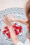 Dance of female hands with mehendi over altar of candles and rose petals, women practices