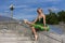 Dance Ideas. Resting Professional Caucasian Ballet Dancer in Green Tutu Dress Posing On Stairs Outdoors