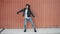 Dance loop of cute girl hipster making wave moves with arms smiling relaxing on wall background