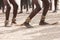 Dance on the sand. Feet of dancing Africans on the sandy surface