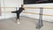 Dance school training. Young handsome guy performs ballet exercises, kick back.