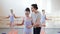 Dance teacher helps girl with exercise on ballet gymnastics classes in a dance