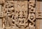 Dance of women near Lakshmi goddess on wall of traditional Hindu stone temple