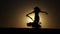 Dancer against the sunset dance the belly dance. Silhouette. Slow motion