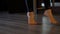 Dancer bare feet step on toes on floor at ballet barre