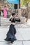 Dancer in a black authentic dress dances to the music for visitors at the annual festival `Jerusalem Knights`