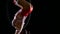 Dancer female balancer in beige leotard back lying hang on aerial hoop on black background. Slow motion. Close up