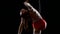 Dancer female balancer in beige leotard back lying hang on aerial hoop on black background. Slow motion. Close up