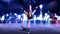 Dancer girl doing standing split exercise, redhead woman wearing headphones with city skyline at night, front view, 3D render