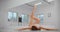 Dancer is lying on the floor of ballet studio and makes warm up exercises for legs, ballet dancer, ballerina in the
