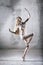 Dancer in a pose with flour on a gray background.