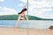 Dancer on pylon riverbank summer beach