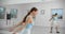 Dancer warms up infromt of the mirror wall in the white bright dance hall before rehearsal, ballet rehearsal, ballerina