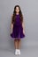 dancewear fashion clothes. happy teen girl junior ballroom dancer. child in purple dance dress