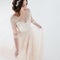 Dancing beautiful girl in a wedding dress. Bride in luxurious dress on a white background